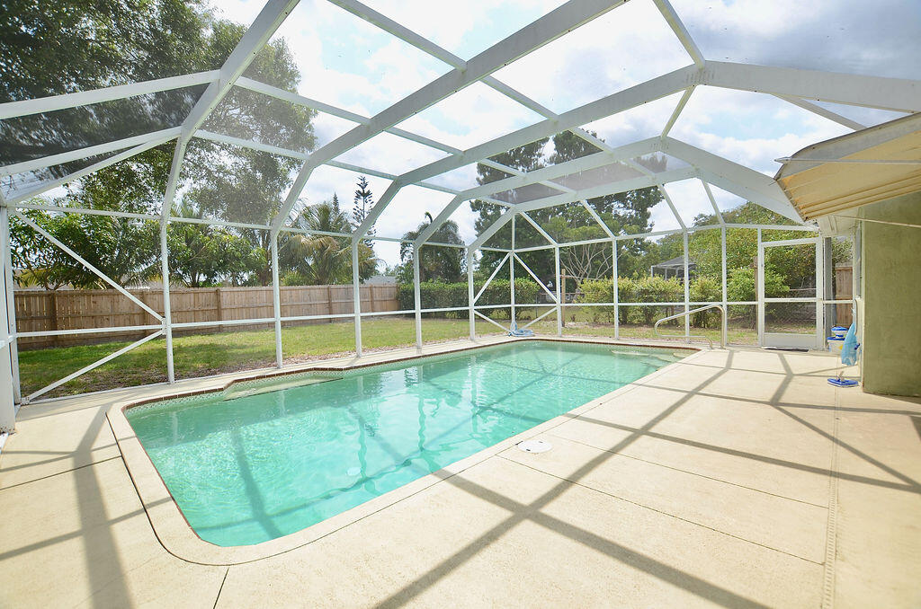 a view of a backyard with a swimming pool