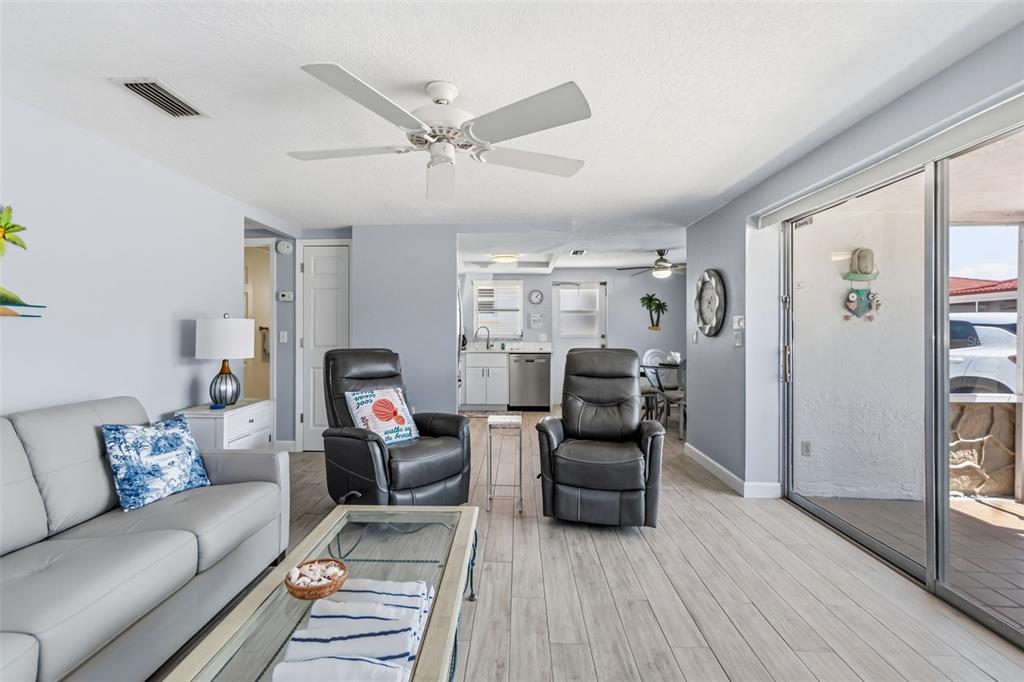 6154 Midnight Pass Road, Unit A05 Sarasota, FL 34242 - Photo 11 of 39 a living room with furniture and a wooden floor