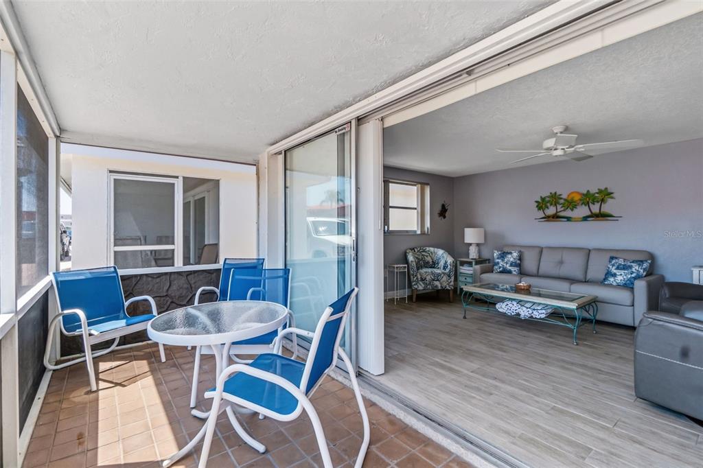 6154 Midnight Pass Road, Unit A05 Sarasota, FL 34242 - Photo 13 of 39 a living room with furniture and wooden floor