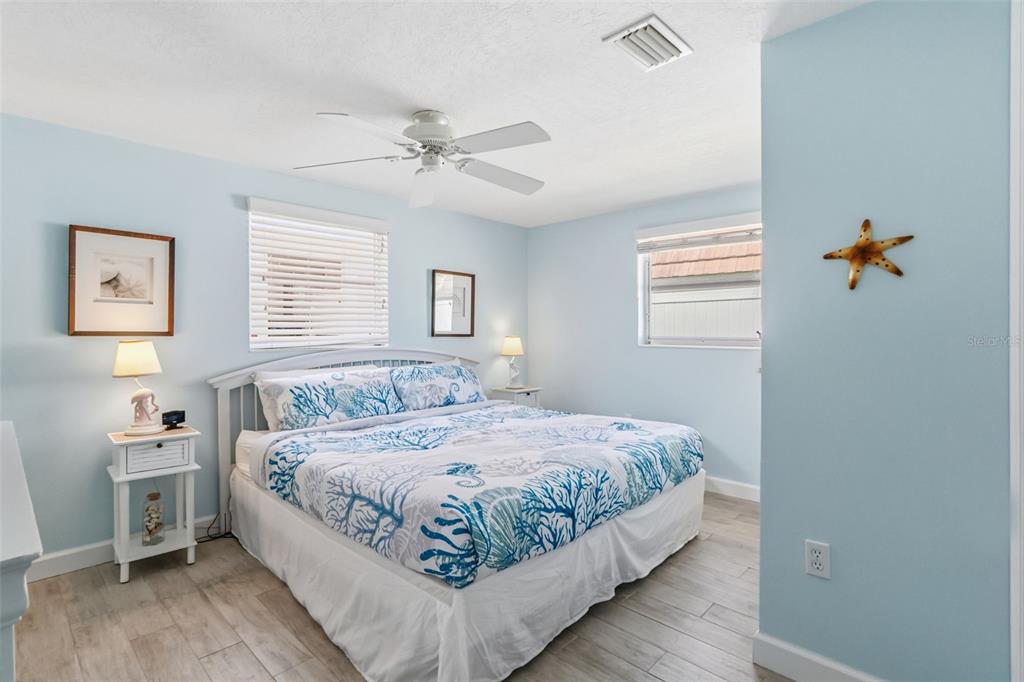 6154 Midnight Pass Road, Unit A05 Sarasota, FL 34242 - Photo 14 of 39 a bedroom with a large bed and a window