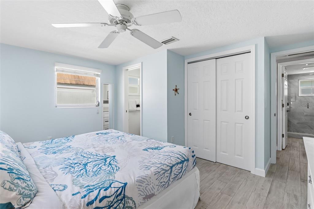 6154 Midnight Pass Road, Unit A05 Sarasota, FL 34242 - Photo 15 of 39 a bedroom with a bed and a window