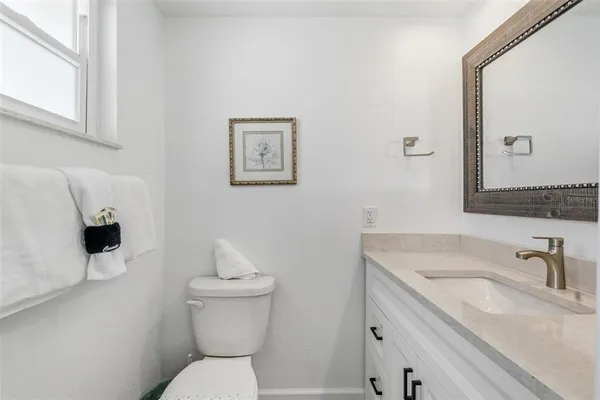a bathroom with a sink toilet and a mirror