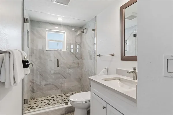 a bathroom with a sink toilet and shower