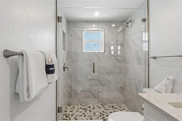 a bathroom with a shower and toilet