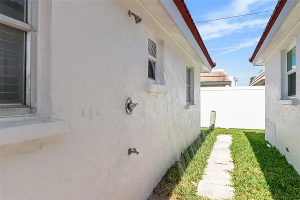 a view of a pathway of a house with a yard