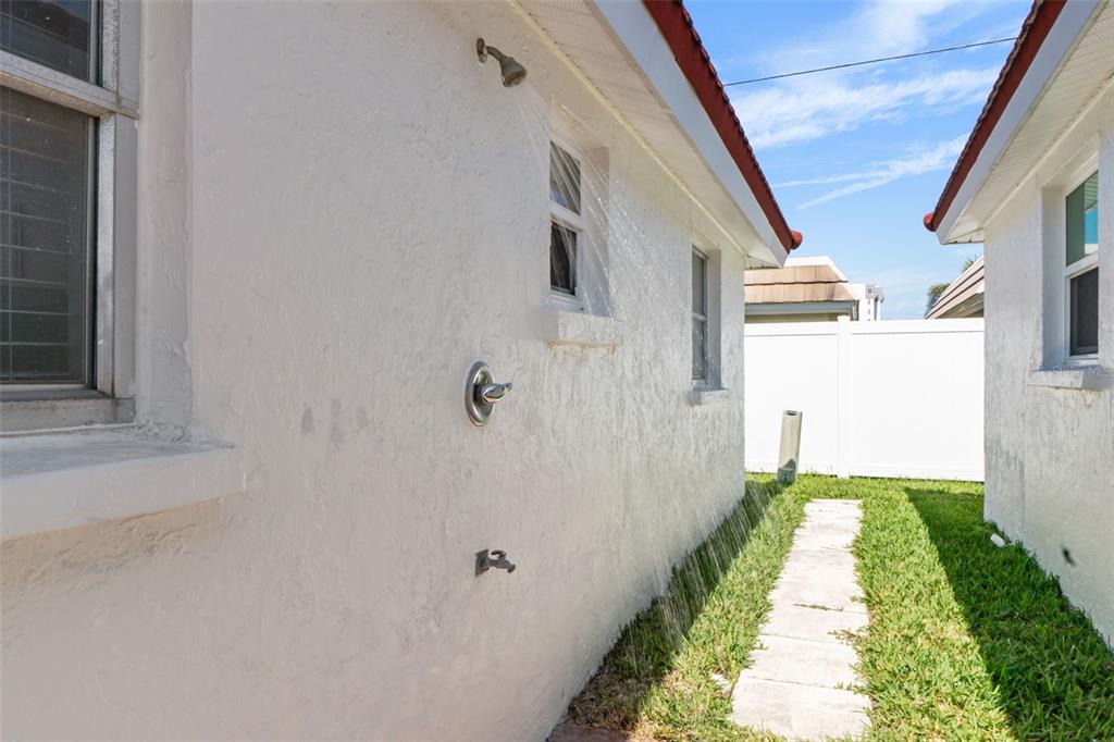 6154 Midnight Pass Road, Unit A05 Sarasota, FL 34242 - Photo 22 of 39 a view of a pathway of a house with a yard