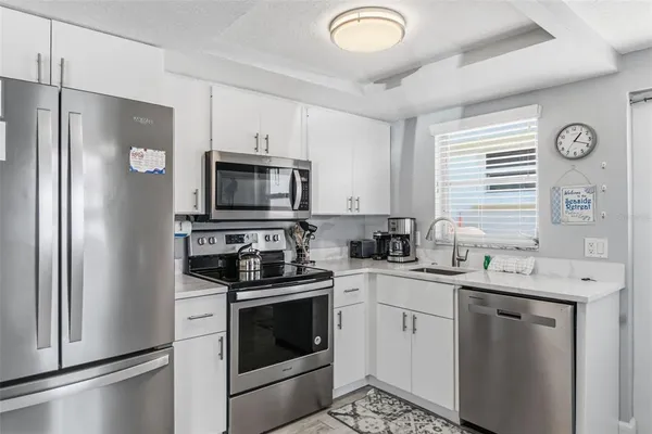 a kitchen with a sink stove and refrigerator