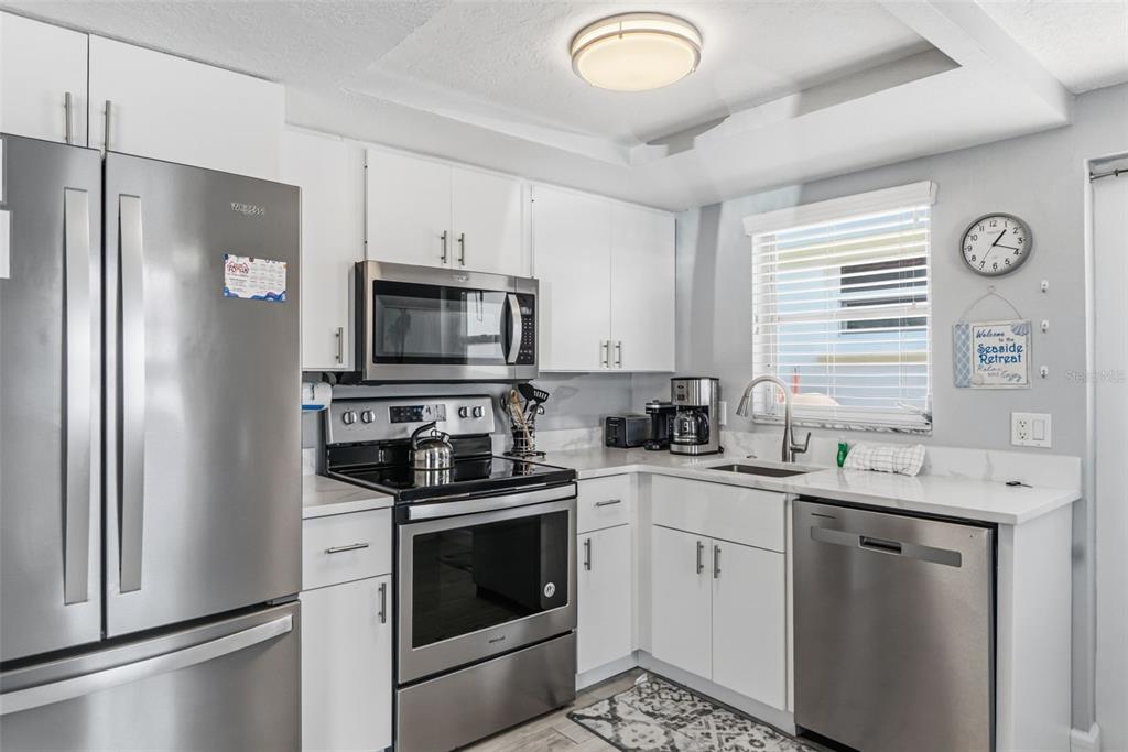 6154 Midnight Pass Road, Unit A05 Sarasota, FL 34242 - Photo 4 of 39 a kitchen with a sink stove and refrigerator