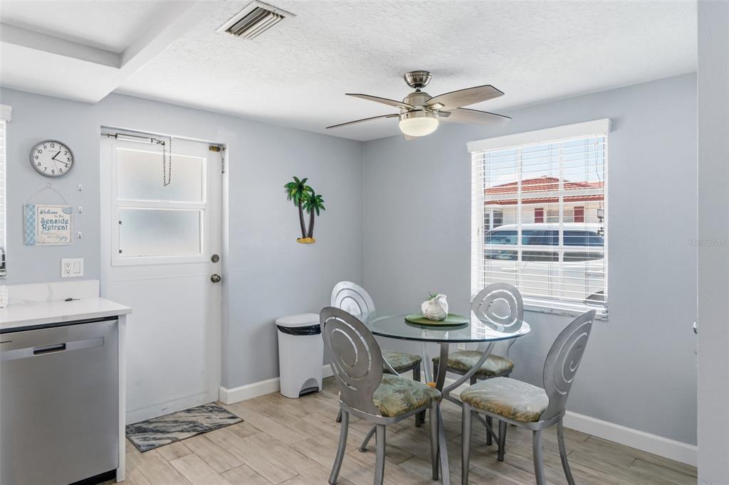 6154 Midnight Pass Road, Unit A05 Sarasota, FL 34242 - Photo 5 of 39 a view of a dining room with furniture window and wooden floor