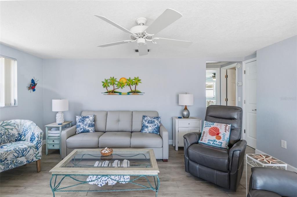 6154 Midnight Pass Road, Unit A05 Sarasota, FL 34242 - Photo 10 of 39 a living room with furniture and painting on the wall