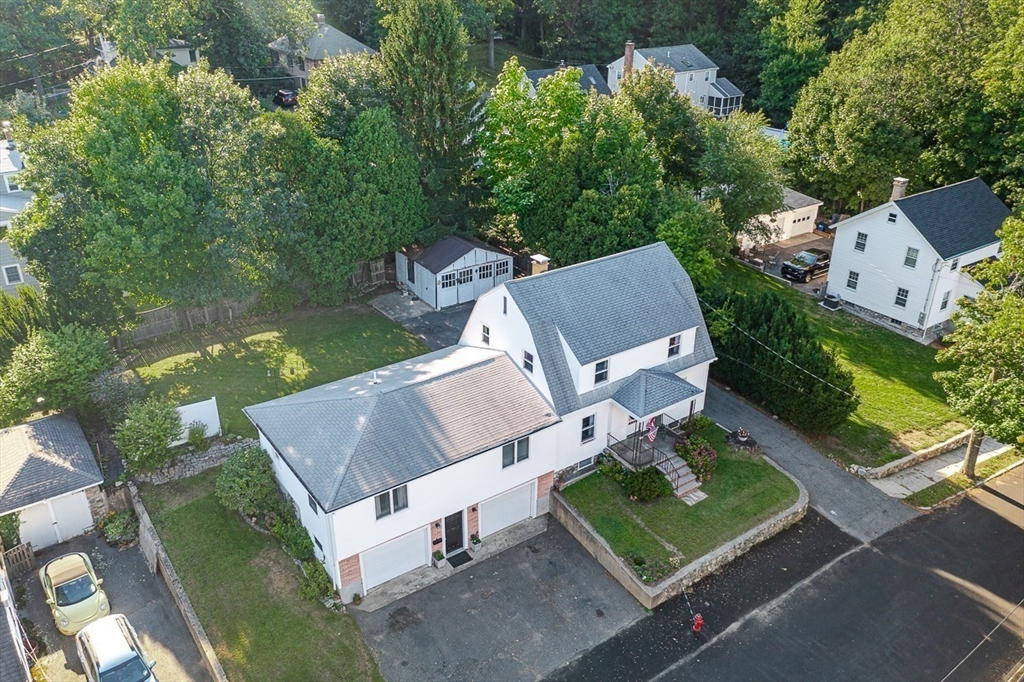an aerial view of a house with garden space and street view
