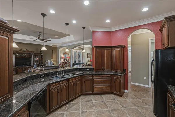 a spacious bathroom with a granite countertop sink a large mirror and a large window