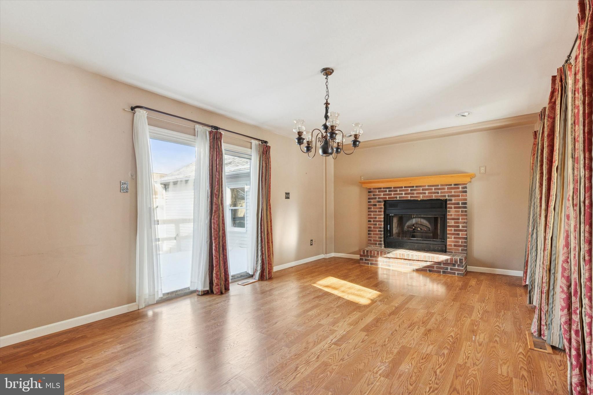 257 Mingo Road Royersford, PA 19468 - Photo 12 of 31 a view of a livingroom with a fireplace a chandelier and wooden floor