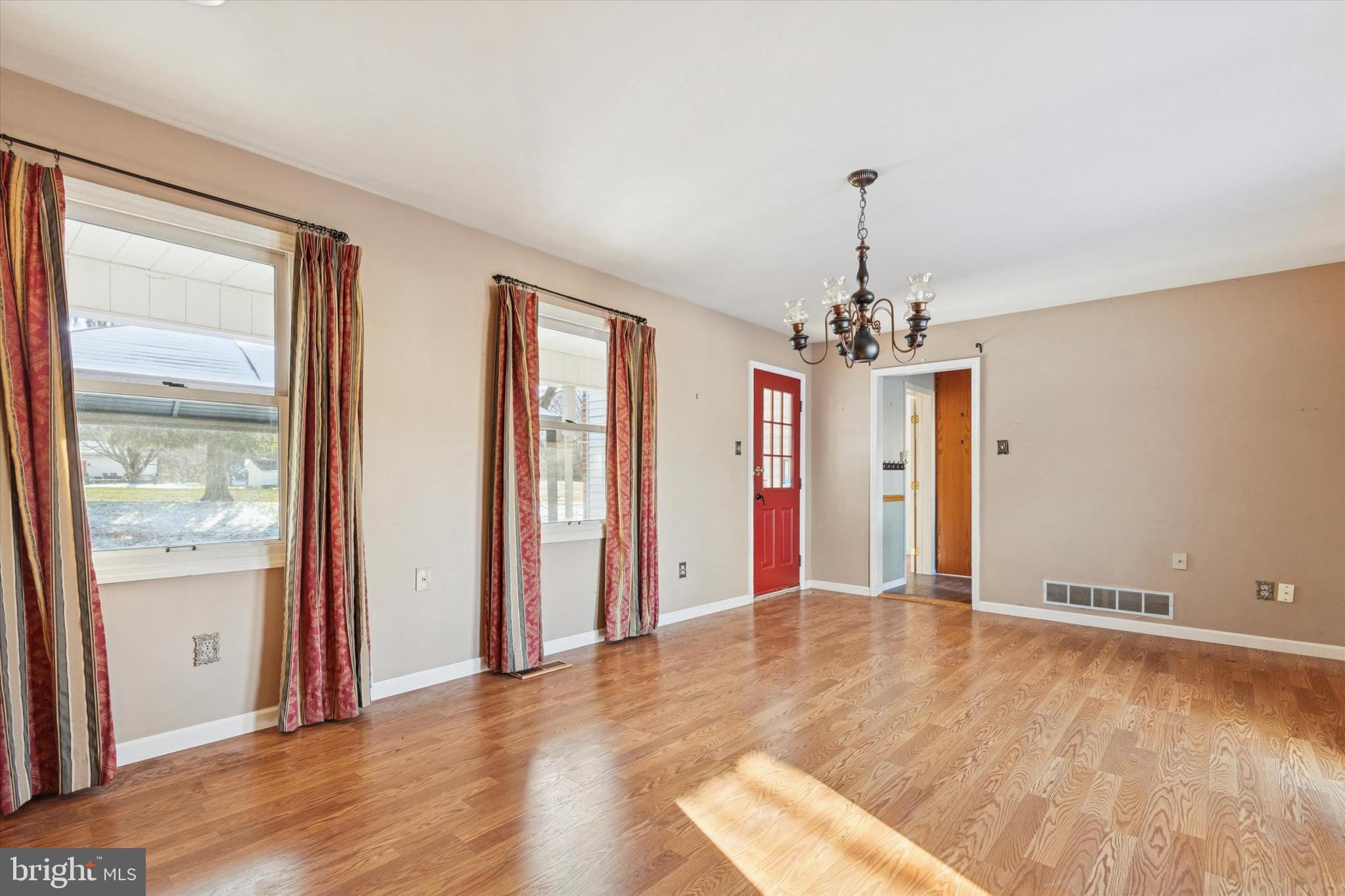 257 Mingo Road Royersford, PA 19468 - Photo 13 of 31 an empty room with wooden floor chandelier and windows