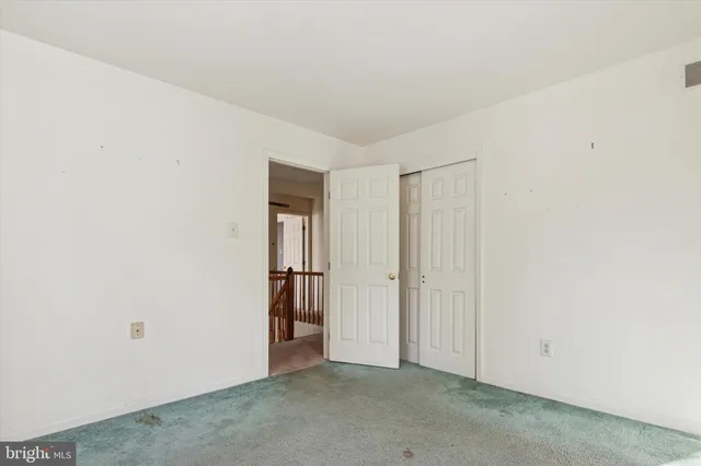 an empty room with windows and closet