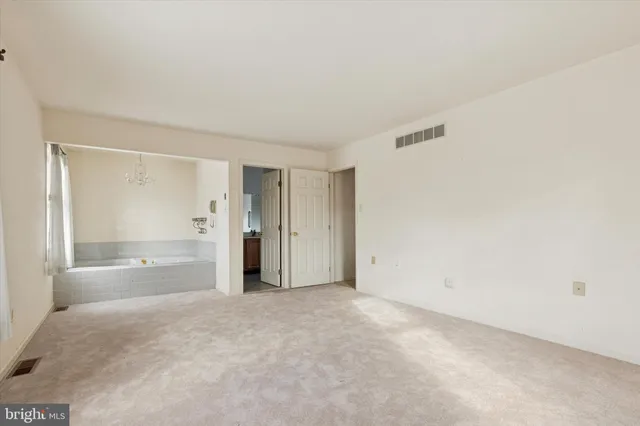 a bathroom with a granite countertop sink and a toilet