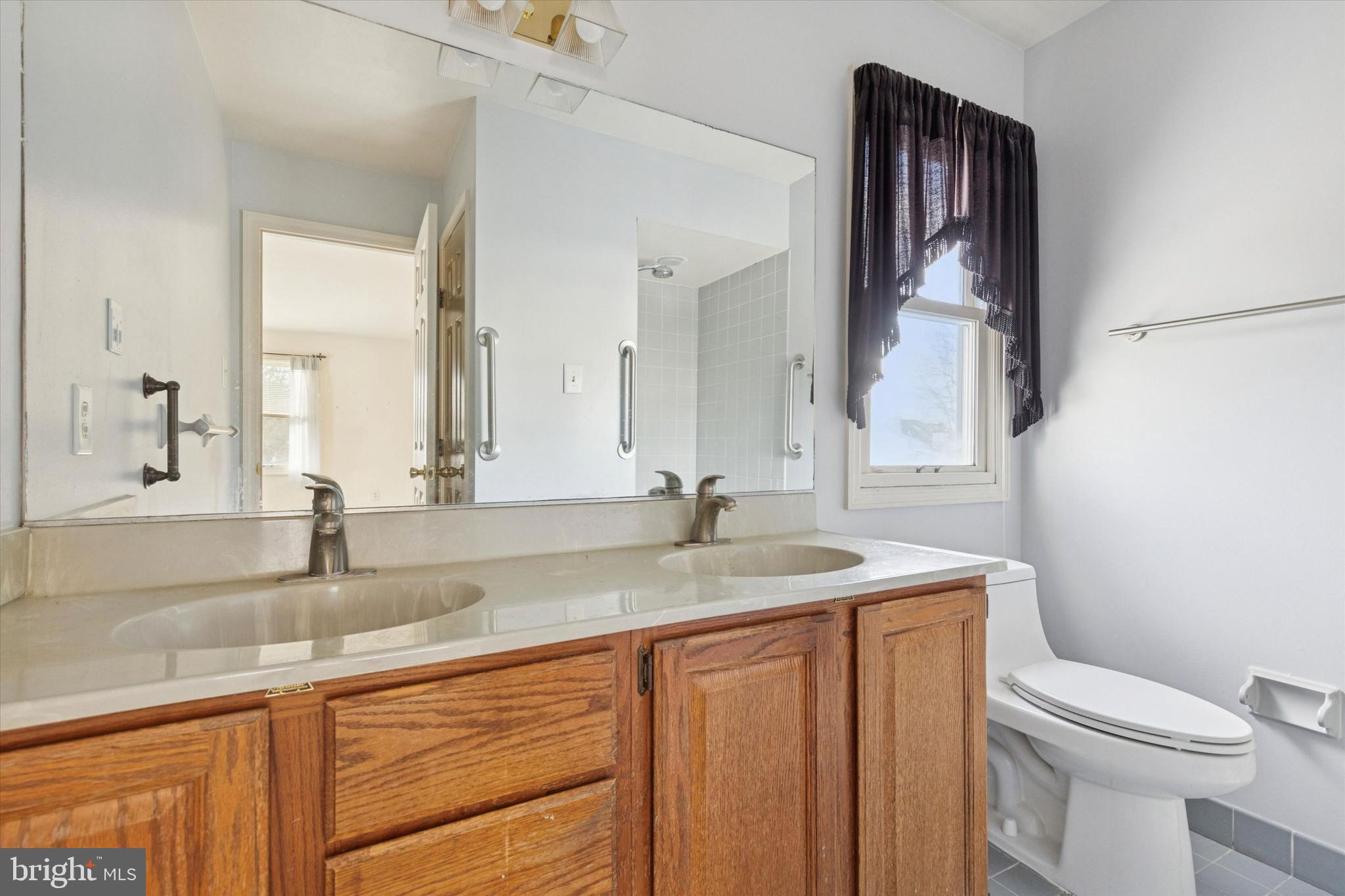 257 Mingo Road Royersford, PA 19468 - Photo 26 of 31 a bathroom with a granite countertop sink and a toilet