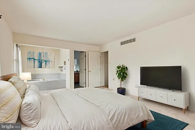 a bedroom with a flat screen television and a bed