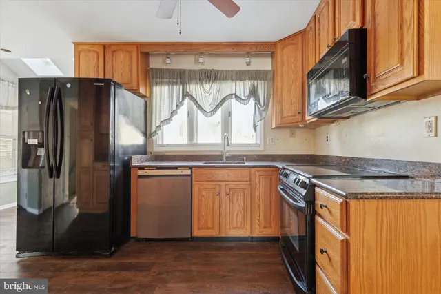 a kitchen with stainless steel appliances granite countertop a refrigerator and a stove