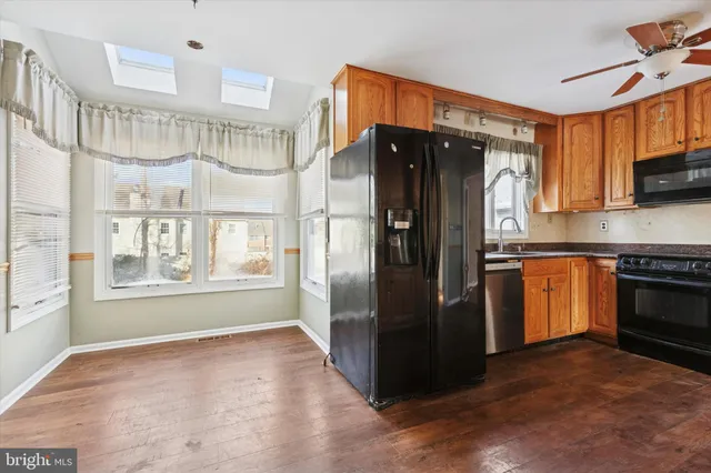 a kitchen with granite countertop a refrigerator stove and oven