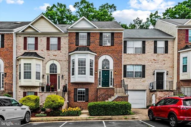 a front view of a residential houses with yard