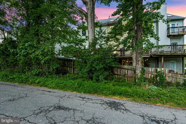 a view of deck with chairs and wooden fence
