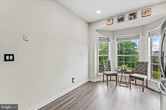 a kitchen with a sink cabinets and wooden floor