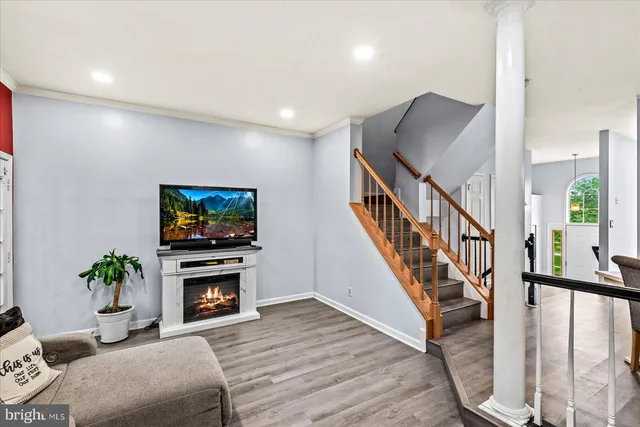 a living room with furniture and stairs