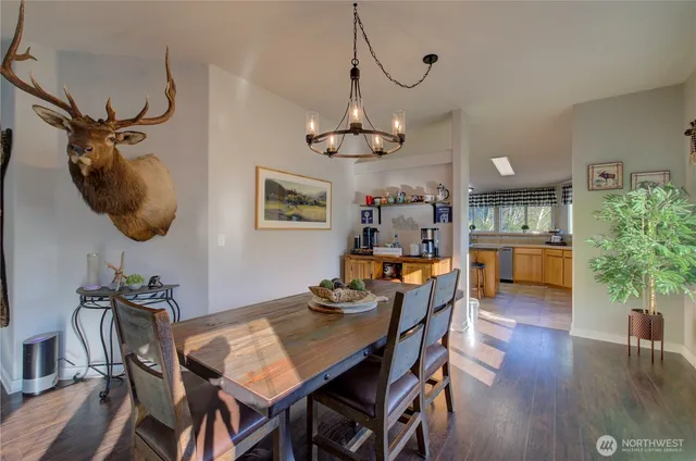 a view of a dining room with furniture wooden floor and chandelier