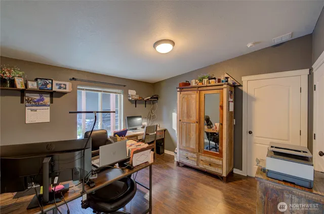 a view of a livingroom with workspace and a window