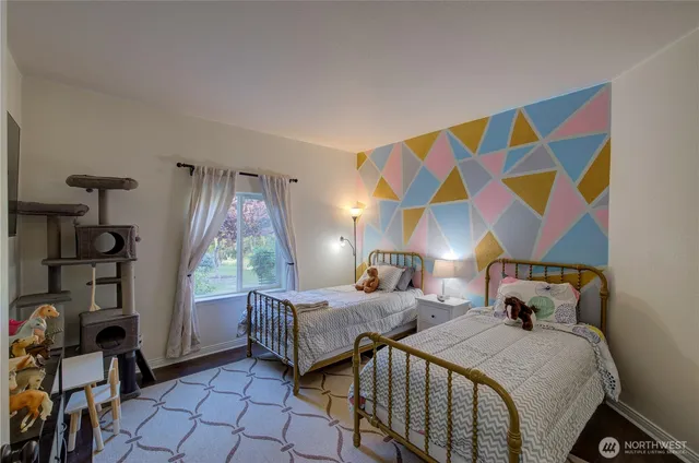 a bedroom with two beds and a window