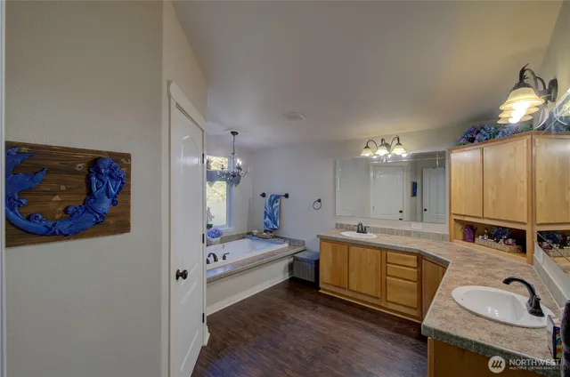 a spacious bedroom with a bed and a view of bathroom