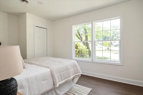a bedroom with a bed and a window