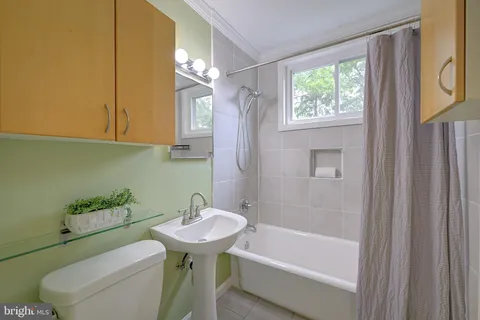 a bathroom with a sink a toilet and bathtub