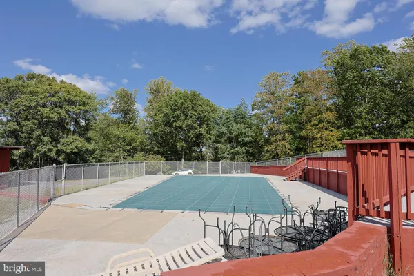 a view of a tennis court with a big yard