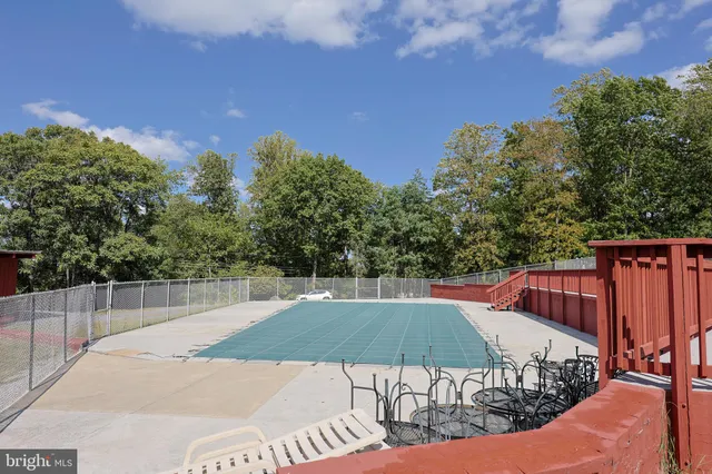 a view of a tennis court with a big yard