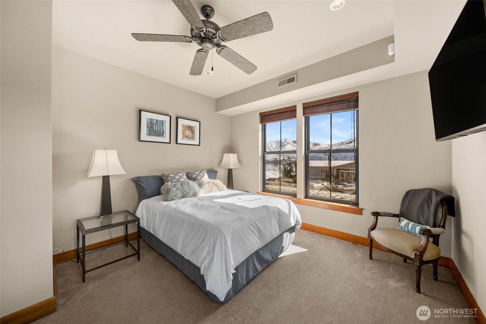 232 Crystal Drive Chelan, WA 98816 - Photo 25 of 39 a spacious bedroom with a bed and a flat screen tv