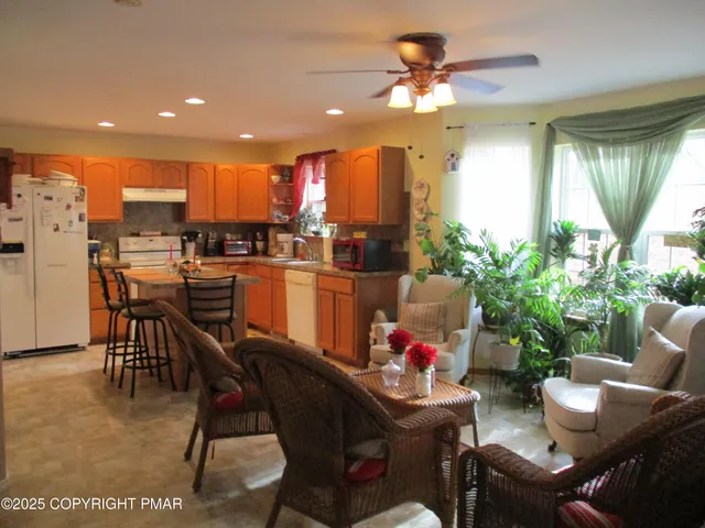 a view of a dining room with furniture and a potted plant