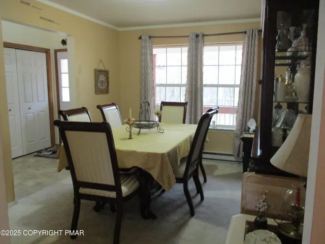 a view of a dining room with furniture window and outside view