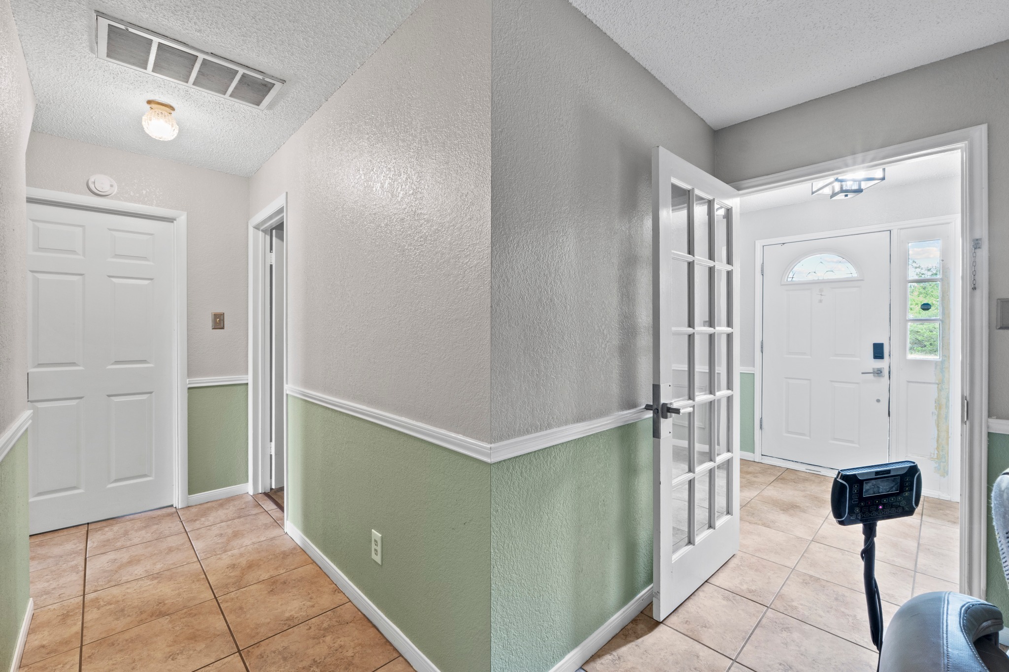 205 Sedro Trail Georgetown, TX 78633 - Photo 30 of 32 Step into a well-lit foyer with tiled flooring and fresh paint, offering a welcoming passage to the home's interior.