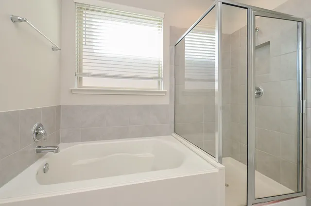 a white bath tub sitting next to a window
