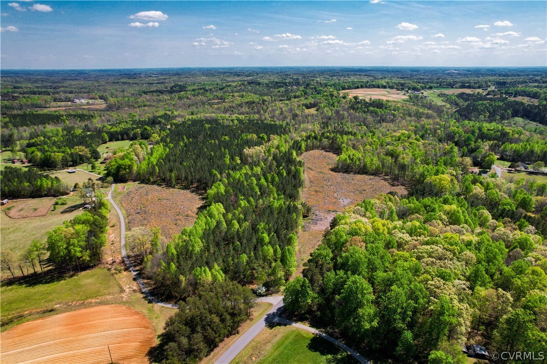 an aerial view of a houses with a yard
