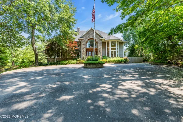 a front view of a house with a yard and potted plants