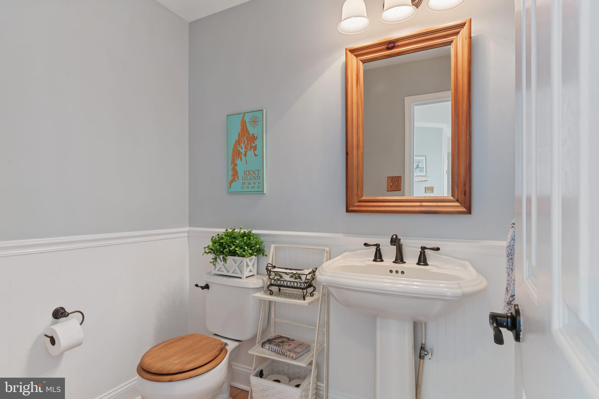2861 Cox Neck Road Chester, MD 21619 - Photo 33 of 79 a bathroom with a sink a mirror and a toilet