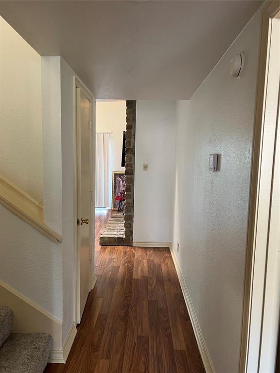 1522 Signal Ridge Place, Unit 1522 Rockwall, TX 75032 - Photo 11 of 28 a view of a hallway with wooden floor and staircase