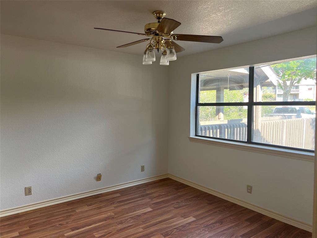 1522 Signal Ridge Place, Unit 1522 Rockwall, TX 75032 - Photo 16 of 28 wooden floor in an empty room with a window