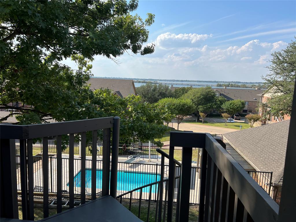 1522 Signal Ridge Place, Unit 1522 Rockwall, TX 75032 - Photo 17 of 28 a view of a balcony with wooden floor and outdoor space
