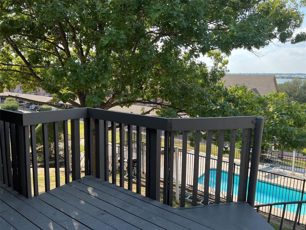 1522 Signal Ridge Place, Unit 1522 Rockwall, TX 75032 - Photo 26 of 28 a balcony with wooden floor and outdoor space