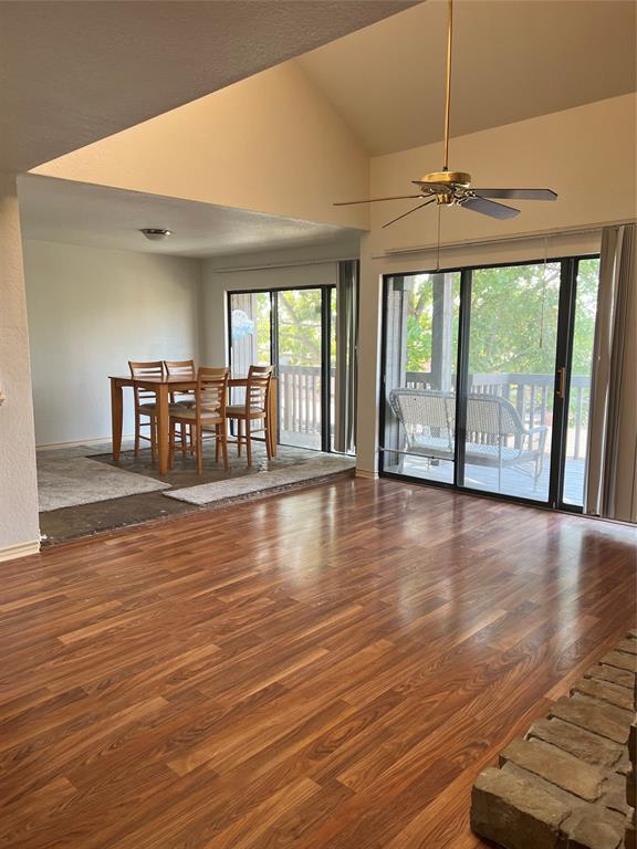 1522 Signal Ridge Place, Unit 1522 Rockwall, TX 75032 - Photo 7 of 28 an empty room with wooden floor fan and windows