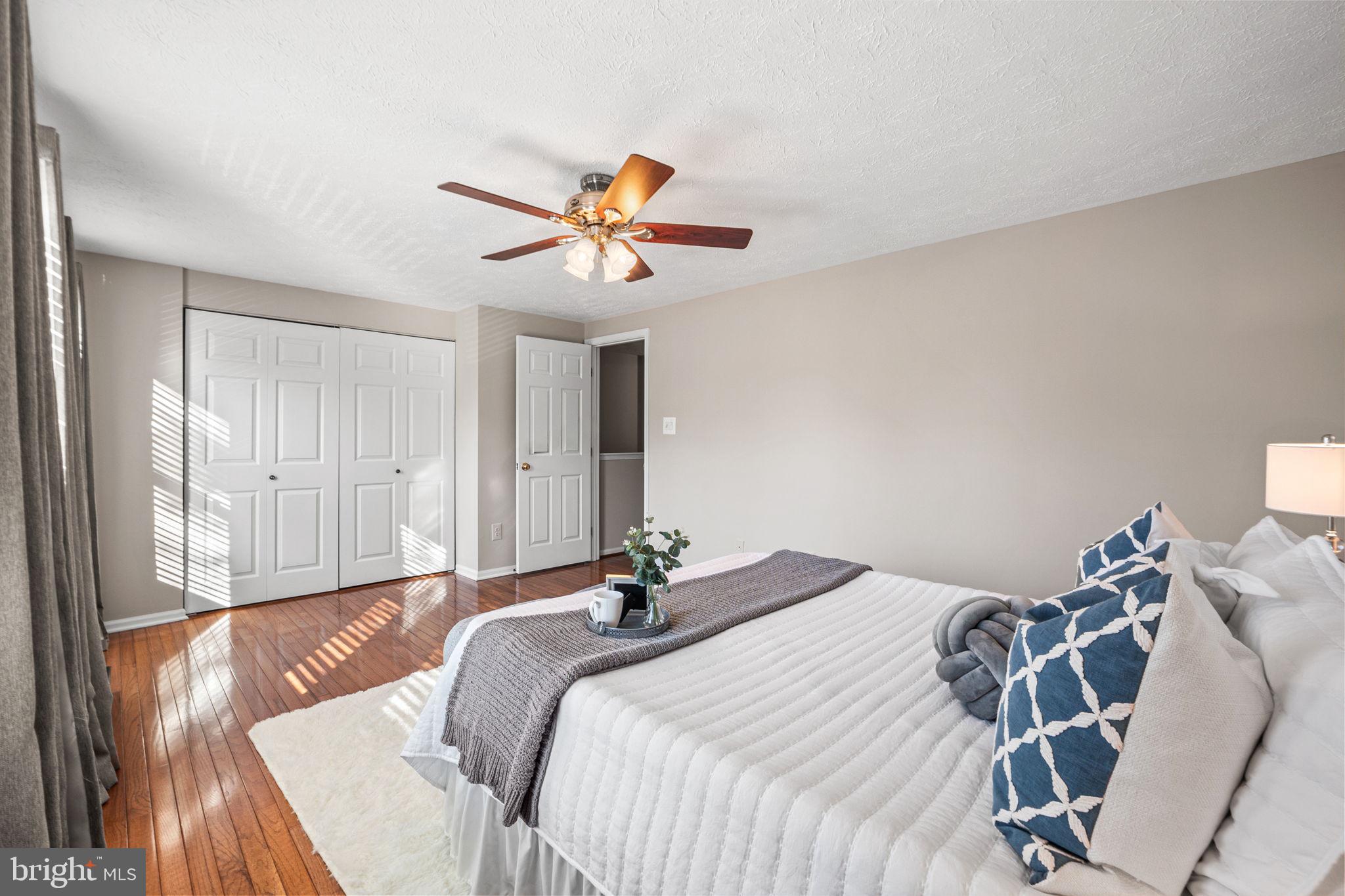 1747 Sundance Drive Reston, VA 20194 - Photo 17 of 36 a bedroom with a bed and a chandelier